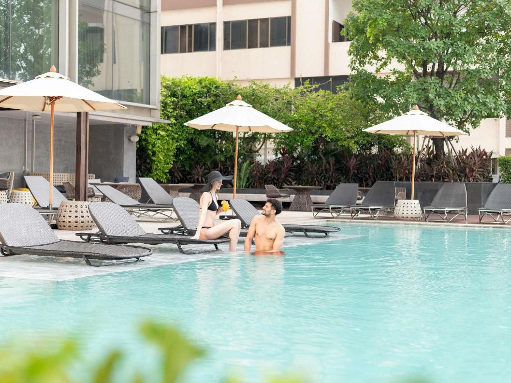 Family enjoying hotel pool in Bangkok