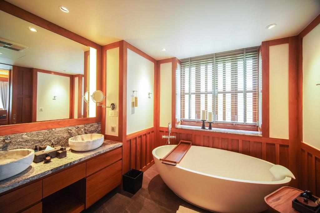 Romantic couple watching sunset at Phuket beach resort”